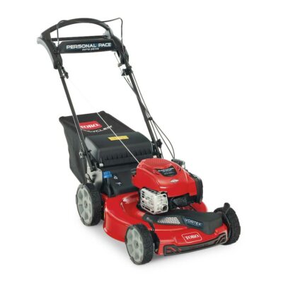 A red lawn mower is parked on the ground.