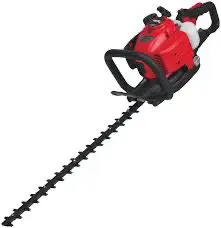 A red and black hedge trimmer is on the ground.