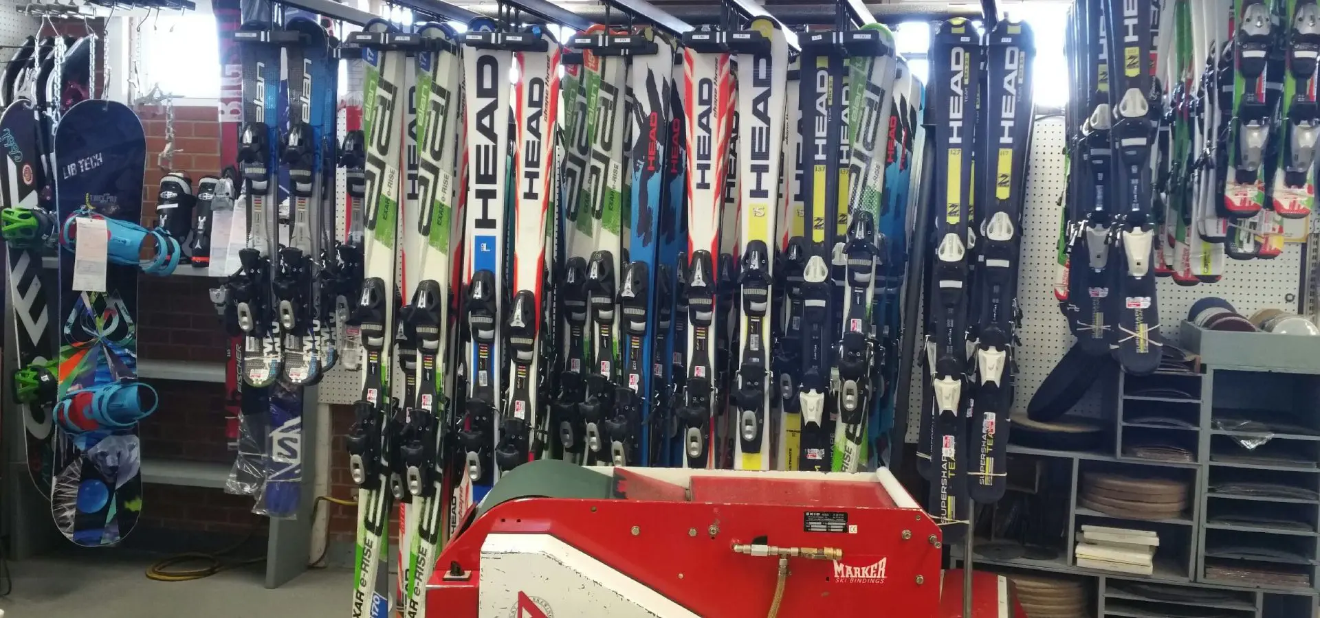 A bunch of skis hanging up in the store